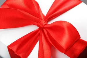 Red bow on a gift made of fabric on a white background photo