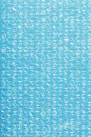 Packing bubble wrap for parcels on a blue background in full screen photo