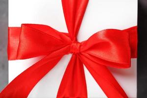 Red bow on a gift made of fabric on a white background photo