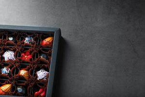 Assorted handmade sweet chocolates in a box photo