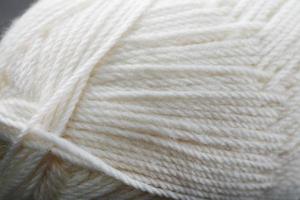 White threads of natural wool close-up in full screen photo