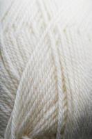 White threads of natural wool close-up in full screen photo