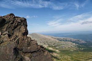 Man on top of mountain. Landscape. photo