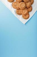 Oatmeal cookies on a napkin on a blue background photo