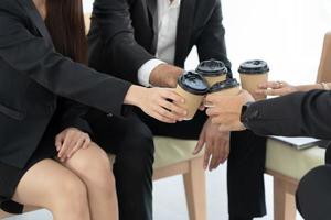 People Meeting Friendship Togetherness Coffee Concept. People hands holding cups of coffee. photo