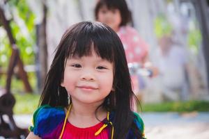 imagen sincera niño de 3-4 años. cara dulce sonrisa niña en el parque infantil. tiro en la cabeza feliz niño adorable verano o primavera. actividad al aire libre. espacio vacío para ingresar texto. foto