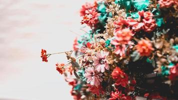 Abstract background of orange fake flower bushes to decorate the walkway. Old wall background. Empty space. photo