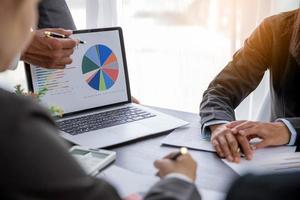 Group professional business people person working together to analyze in office, work together to discuss company financial statistics report, brainstorm ideas, and graph datum documents on the table. photo