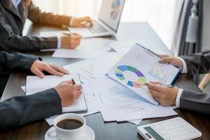 Group professional business people person working together to analyze in office, work together to discuss company financial statistics report, brainstorm ideas, and graph datum documents on the table. photo