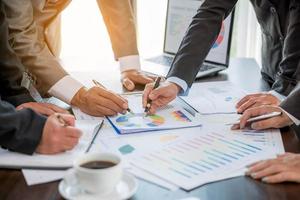 Group professional business people person working together to analyze in office, work together to discuss company financial statistics report, brainstorm ideas, and graph datum documents on the table. photo