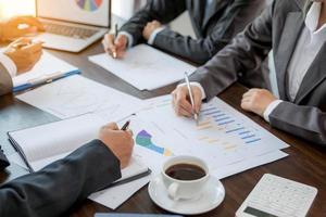 Group professional business people person working together to analyze in office, work together to discuss company financial statistics report, brainstorm ideas, and graph datum documents on the table. photo
