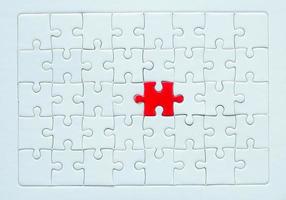 White part of jigsaw puzzle pieces on blue background. concepts of problem solving, business success, teamwork, Team playing jigsaw game incomplete, Texture photo with copy space for text