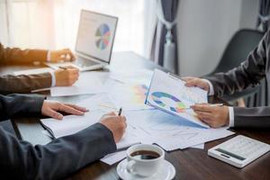 Group professional business people person working together to analyze in office, work together to discuss company financial statistics report, brainstorm ideas, and graph datum documents on the table. photo