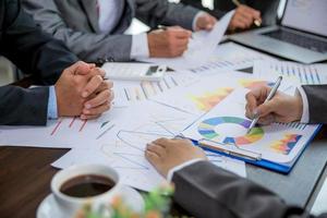 Group professional business people person working together to analyze in office, work together to discuss company financial statistics report, brainstorm ideas, and graph datum documents on the table. photo
