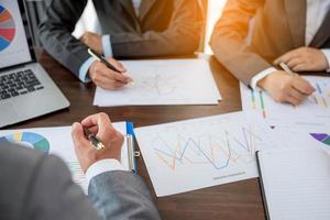 Group professional business people person working together to analyze in office, work together to discuss company financial statistics report, brainstorm ideas, and graph datum documents on the table. photo