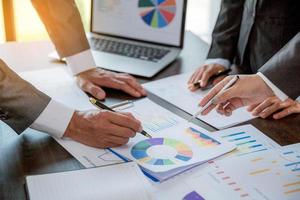 Group professional business people person working together to analyze in office, work together to discuss company financial statistics report, brainstorm ideas, and graph datum documents on the table. photo