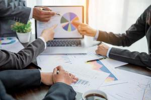 Group professional business people person working together to analyze in office, work together to discuss company financial statistics report, brainstorm ideas, and graph datum documents on the table. photo