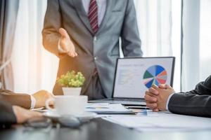 Group professional business people person working together to analyze in office, work together to discuss company financial statistics report, brainstorm ideas, and graph datum documents on the table. photo