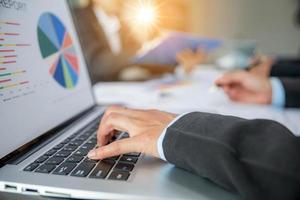 Group professional business people person working together to analyze in office, work together to discuss company financial statistics report, brainstorm ideas, and graph datum documents on the table. photo