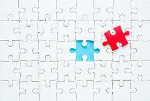 White part of jigsaw puzzle pieces on blue background. concepts of problem solving, business success, teamwork, Team playing jigsaw game incomplete, Texture photo with copy space for text
