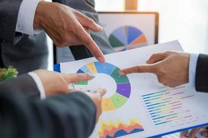 Group professional business people person working together to analyze in office, work together to discuss company financial statistics report, brainstorm ideas, and graph datum documents on the table. photo