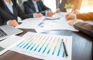 Group professional business people person working together to analyze in office, work together to discuss company financial statistics report, brainstorm ideas, and graph datum documents on the table. photo