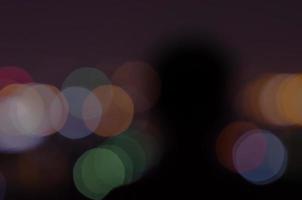Blurred shadow for a person at night with colorful bokeh light. photo