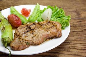 Grilled steak meat with vegetable salad photo