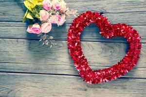 Tinsel heart  decoration on wood background,filter effect. photo