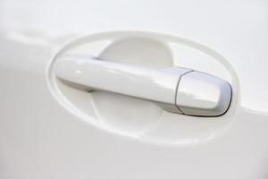 closeup white car door handle photo