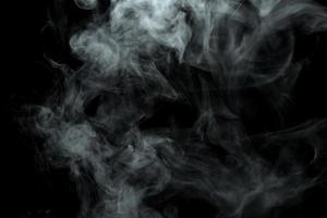 Abstract powder or smoke isolated on black background photo