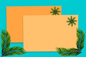 Green palm leaves pattern for nature concept,tropical leaf on orange and teal paper background photo