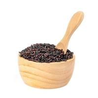 dark violet rice berry with wooden bowl and spoon isolated on white background photo