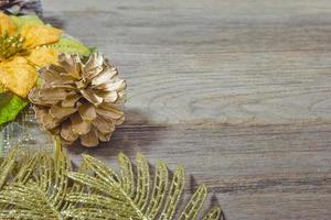 pine cones and gold leaf on the wooden board,christmas background photo