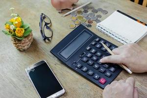 Woman using calculator on desktop photo