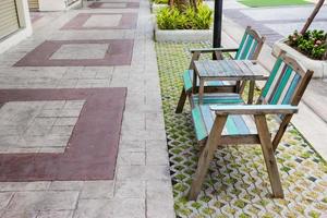 Old wooden chairs outdoors with bricks floor photo