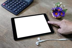 Man using tablet computer on desktop photo