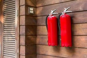 Fire extinguisher on wooden wall. photo