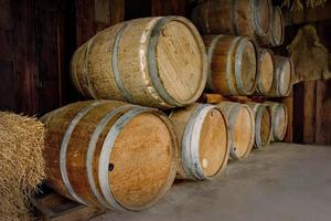old wooden barrels stacked in winery photo