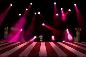 top desk with light bokeh in concert blur background,red wooden table photo