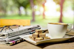 coffee and newspaper with nature background photo