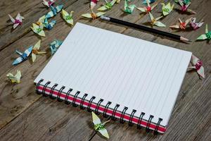 open note book with pencil on wood background photo