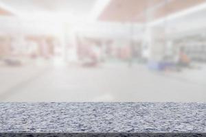 Marble table with blur fitness gym equipment background photo