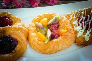 danish pastry with fruits on white dish photo