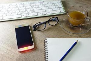 Buttons with light on smart phone and keyboard pencil notebook photo