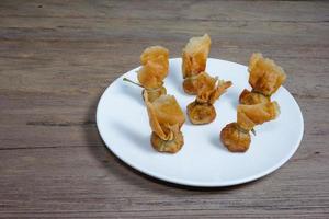 fried wonton or Toong Tong on wood background photo