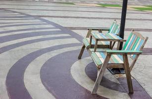 Old wooden chairs outdoors with bricks floor photo