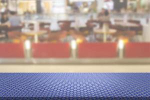 Knitted Cotton Fabric Table with Blur Restaurant Background photo