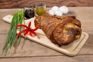 fried pork leg cooked on chopping block photo