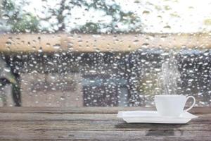 coffee cup on a rainy day with morning sunlight photo